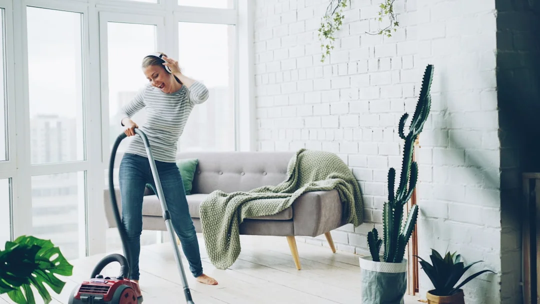 A pair working together to carry a sofa as they move into a new apartment.